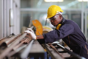 African American mechanic engineer worker is choosing copper tub
